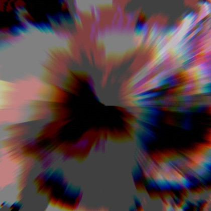 A friendly-looking squirrel with a bushy tail perched attentively on a wooden fence in natural outdoor surroundings